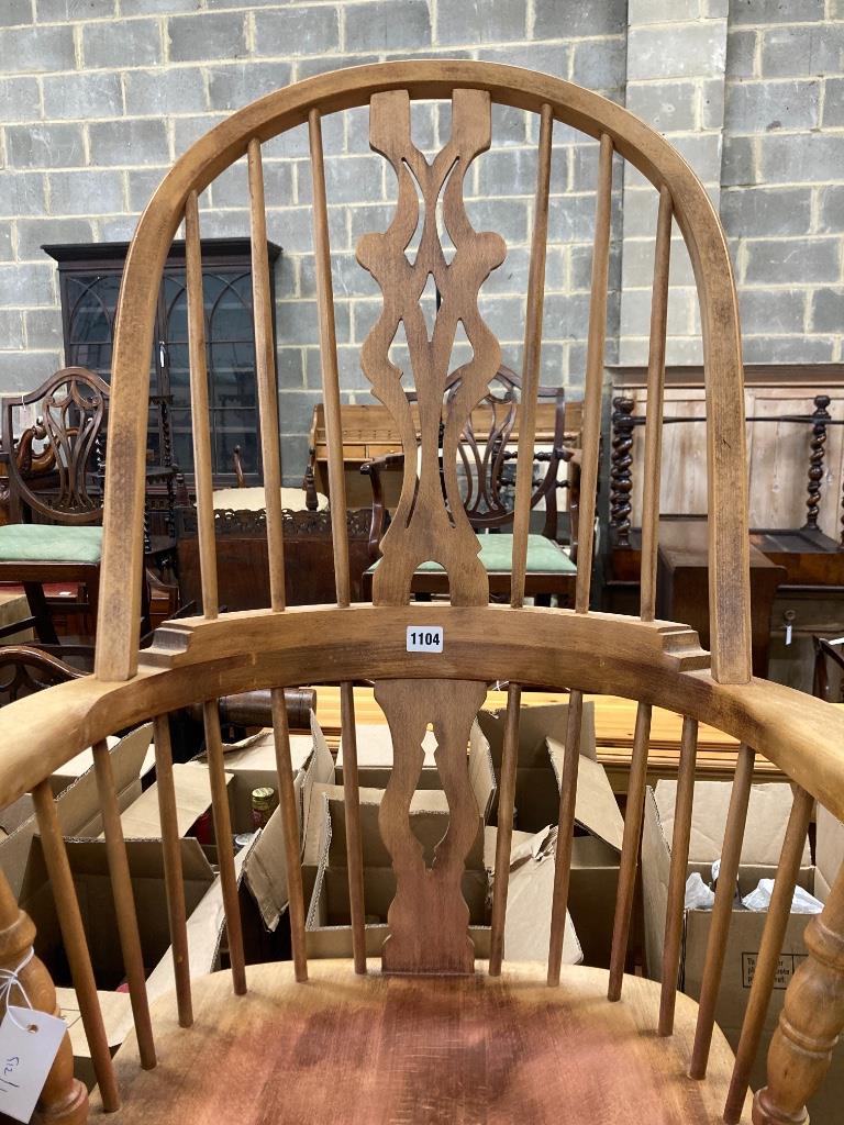 A reproduction beech Windsor rocking chair, width 63cm, depth 52cm, height 110cm